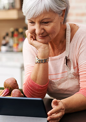 Woman looking at tablet for healthy eating recipe