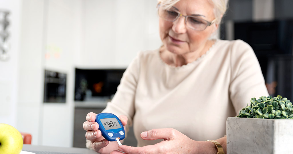 Senior women checking blood sugar levels