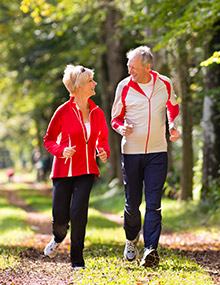 Elderly couple going for jog together in park